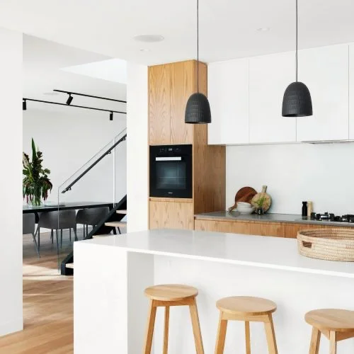Open-plan oak kitchen with a pale worktop